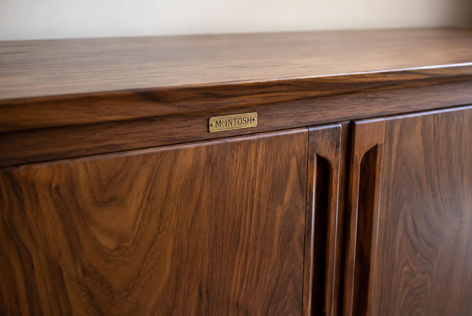Walnut grain and brass nameplate detail