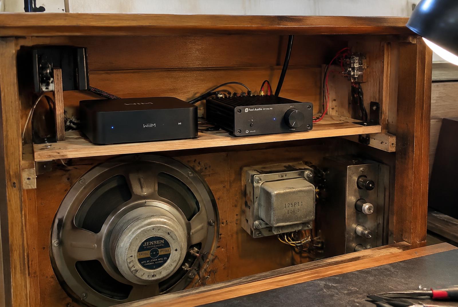 Modern audio electronics installed within the vintage console cabinet